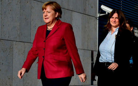 Angela Merkel arrives at the CDU's headquarters for further exploratory talks with members of potential coalition parties - Credit: JOHN MACDOUGALL/AFP/Getty Images