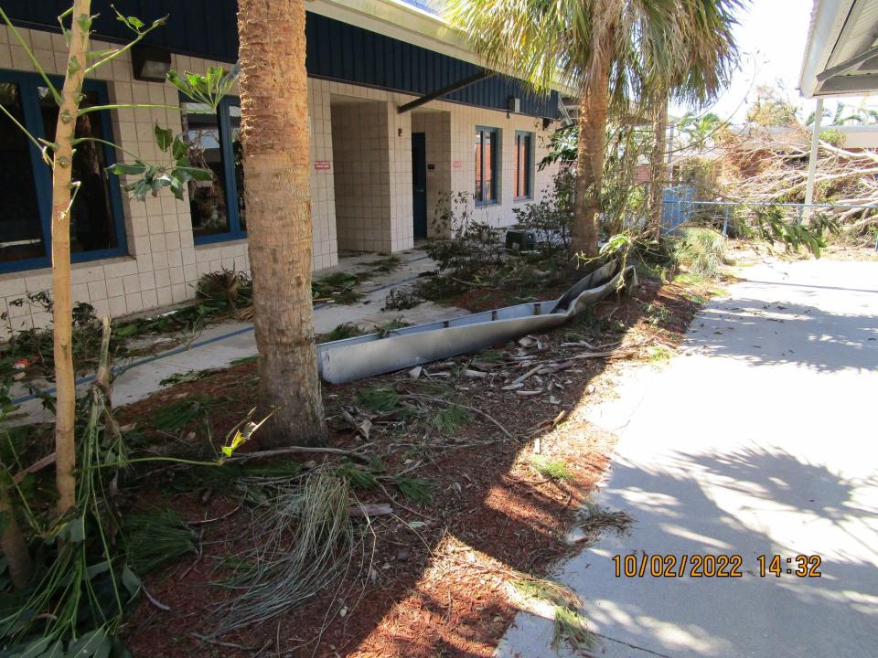 A gutter broken off The Sanibel School lays on the ground.