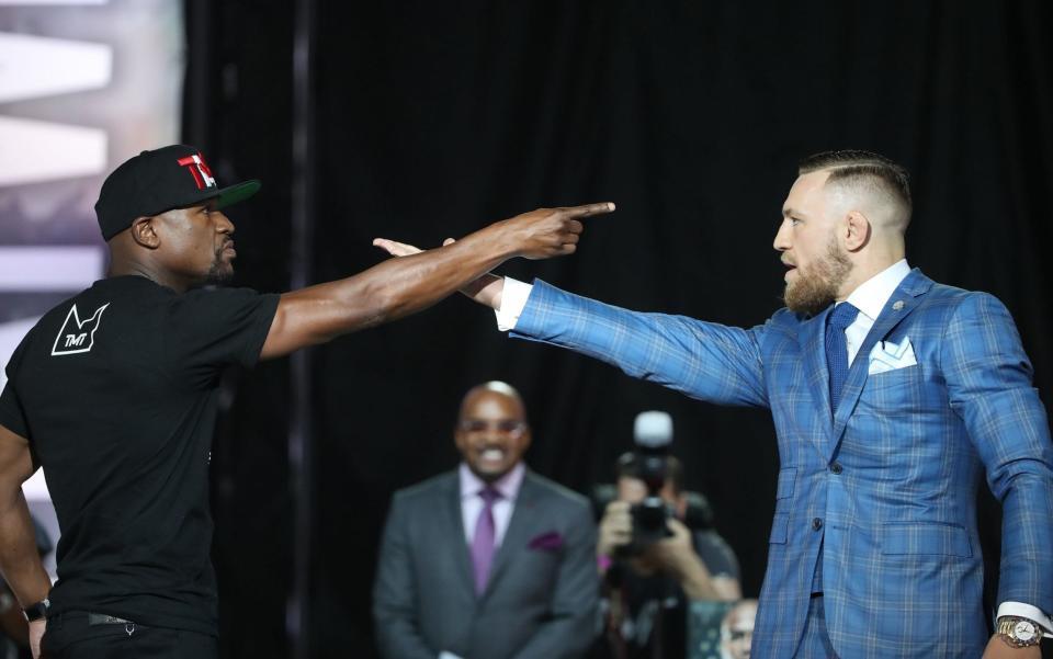 Floyd Mayweather and Conor McGregor face off at one of their press conferences.