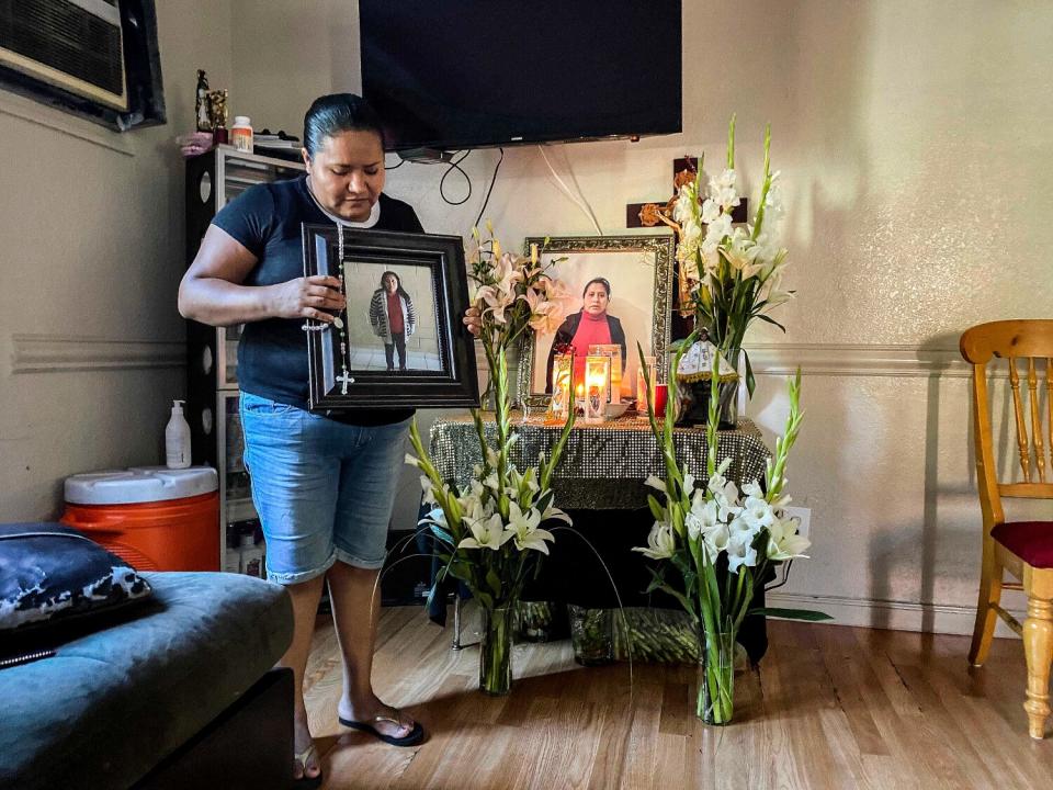 One of Maria Eugenia Chavez Segovia's sisters, Gabriela, clutches a picture of her at her home in Northern California.