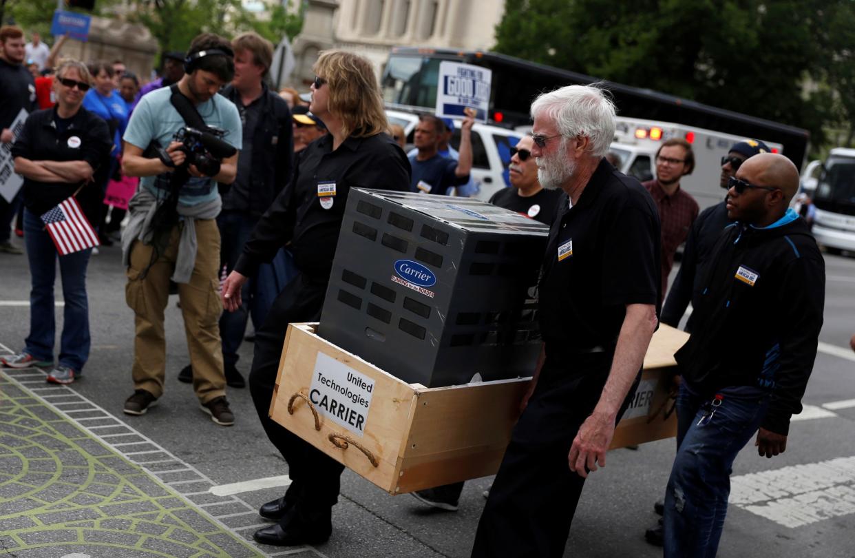 People protest against the outsourcing of jobs by Carrier at a rally hosted by the United Steel Workers.