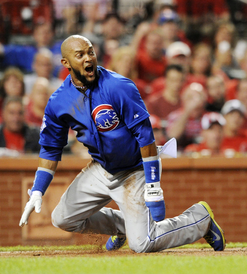 Chicago Cubs' Emilio Bonifacio reacts after being called out at the plate against the St. Louis Cardinals in the fourth inning in a baseball game, Monday, May 12, 2014, at Busch Stadium in St. Louis. The call was reversed after a challenge review. (AP Photo/Bill Boyce)