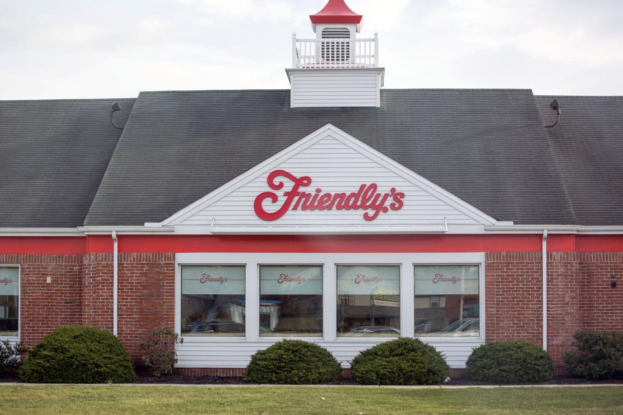 Exterior of Friendly's restaurant in Lancaster, Pennsylvania, windows, shrubbery, and green grass against a light blue sky