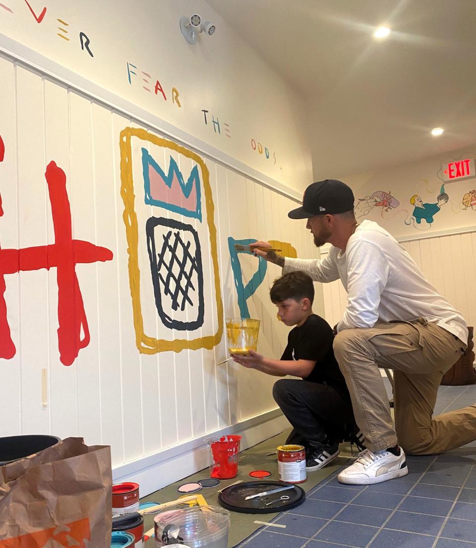 Artist Philip Easton paints with his 10-year-old son Izaiah Ramsey Landers.