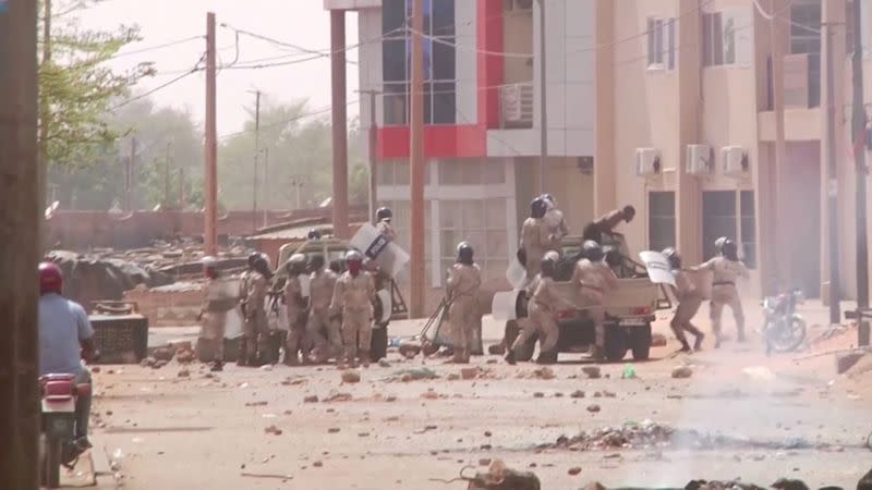 FILE PHOTO: Video grab of riot policemen detaining protesters in Niamey, Niger