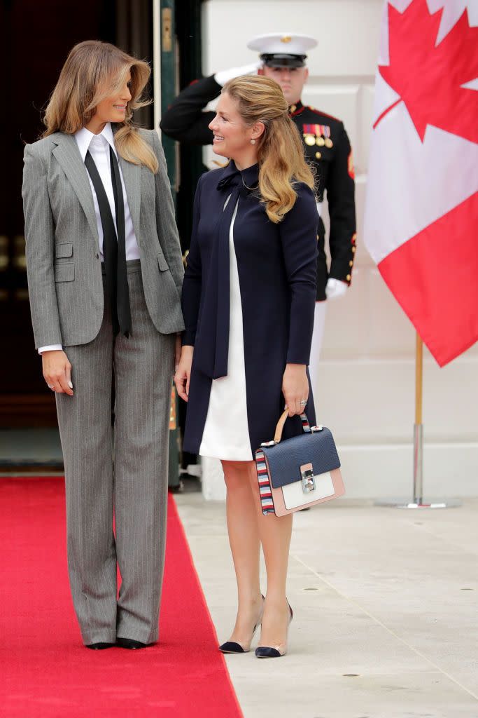 <p>The First Lady greeted Canadian Prime Minister Justin Trudeau and his wife in a statement pantsuit—<a href="https://www.townandcountrymag.com/society/politics/a13101015/melania-ivanka-trump-ralph-lauren-suit/" rel="nofollow noopener" target="_blank" data-ylk="slk:a favorite style of hers;elm:context_link;itc:0;sec:content-canvas" class="link ">a favorite style of hers</a>. She paired with a white collared button up shirt, and a loose black tie. </p>