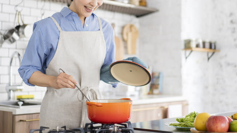 Person stirring pot of soup