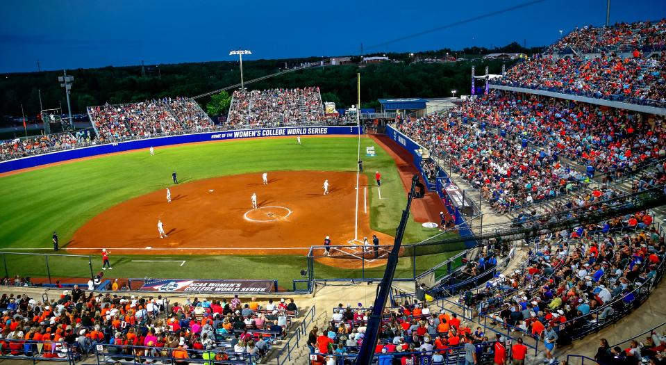 Fans watch a Women's College World Series softball game between the Oklahoma State Cowgirls and the Arizona Wildcats at the USA Softball Hall of Fame Stadium in Oklahoma City in 2022. The site was renamed Devon Park recently and will continue to host the WCWS close to Oklahoma's campus.