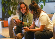 Saskia Niño de Rivera, right, a Mexican civil rights activist, and her girlfriend Mariel Duayhe, a sports agent for Mexican soccer players, share a moment at their apartment in Mexico City, Tuesday, Nov. 8, 2022. Saskia Niño de Rivera contemplated privately proposing in Qatar at the World Cup during a game, but as the lesbian couple learned more about laws against same-sex relations in the conservative Gulf country, she decided against the idea. (AP Photo/Fernando Llano)