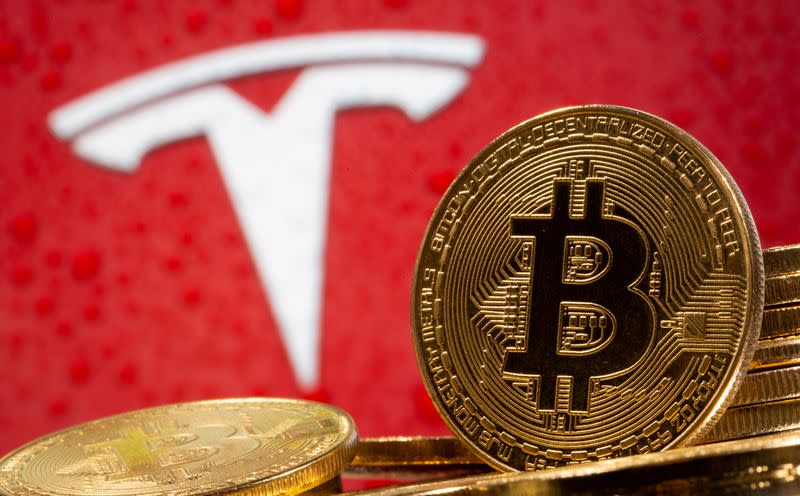 FILE PHOTO: FILE PHOTO: FILE PHOTO: Representations of virtual currency Bitcoin are seen in front of Tesla logo in this illustration