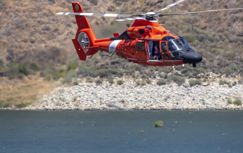 LAKE PIRU, CA - JULY 09: A US Coast Guard helicopter searches along the Lake Piru shoreline for missing actress Naya Rivera on Thursday, July 9, 2020 in Lake Piru, CA. (Brian van der Brug / Los Angeles Times)