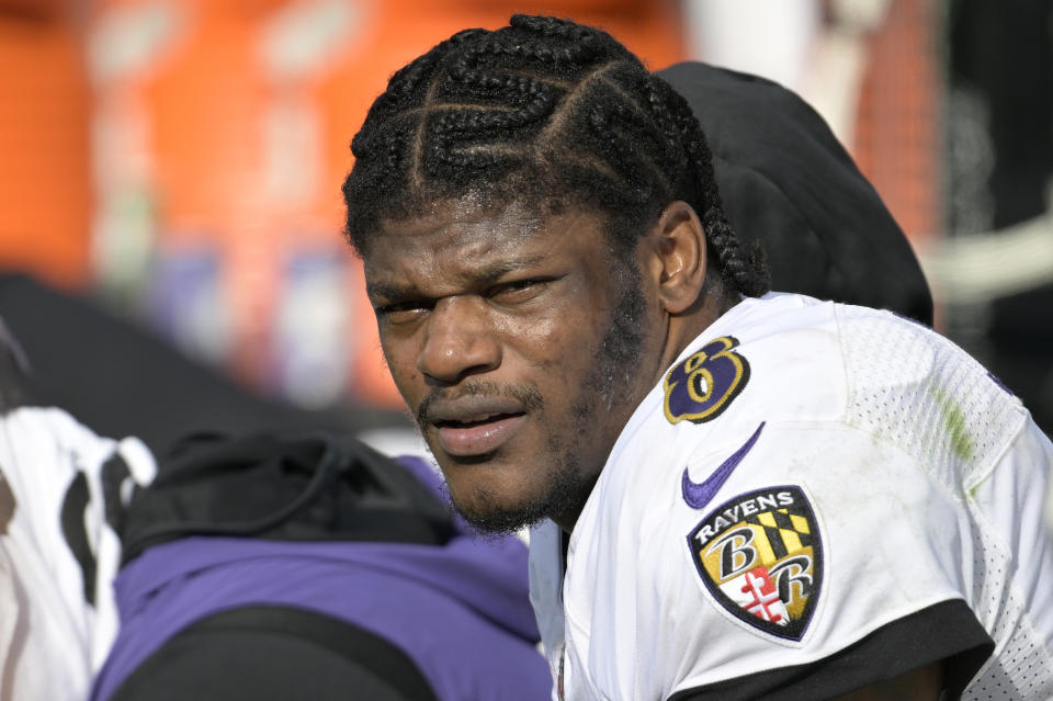 FILE - Baltimore Ravens quarterback Lamar Jackson (8) watches from the sideline during the first half of an NFL football game against the Jacksonville Jaguars, Sunday, November 27, 2022, in Jacksonville, Florida.  Lamar Jackson was again absent from practices during a segment open to reporters Wednesday, January 11, 2023. The Baltimore star hasn't practiced since injuring his knee in the Dec. 4 win over Denver, and there was no sign of him Wednesday as the Ravens prepare Sunday night' ;  s opener in Cincinnati.  Jackson missed the final five games of the regular season.  (AP Photo/Phelan M. Ebenhack, File)