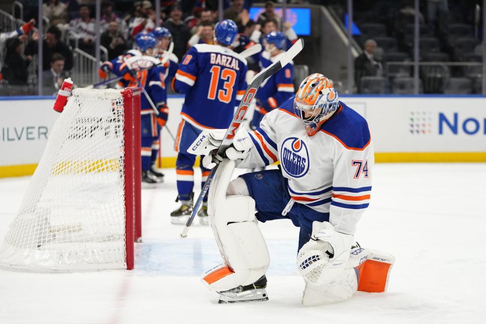 Edmonton Oilers goaltender Stuart Skinner (74) pauses as the New York Islanders celebrate a goal by Bo Horvat during the second period of an NHL hockey game Tuesday, Dec. 19, 2023, in Elmont, N.Y. (AP Photo/Frank Franklin II)