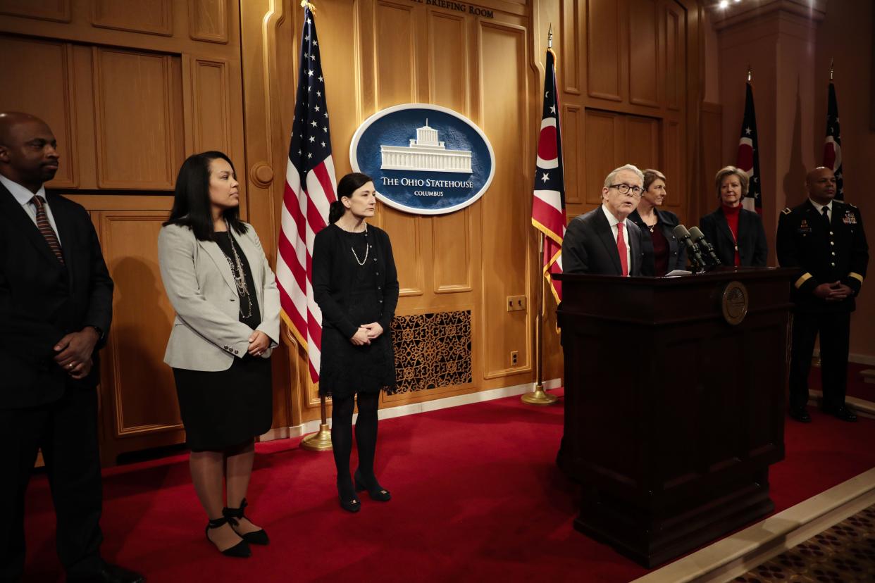 Ohio Gov. Mike DeWine announces cabinet nominees, including Laurel Dawson to his right.