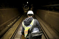 Mike Galluccio, chief signal construction supervisor, walks along the rail for the PATH train system near the Hoboken Terminal during a media tour to show damages to the line caused by Superstorm Sandy, Tuesday, Nov. 27, 2012, in Hoboken, N.J. While other parts of the trans-Hudson service have gradually returned to service since the storm, the Hoboken station has been closed, leaving thousands of commuters to seek alternatives. (AP Photo/Julio Cortez)