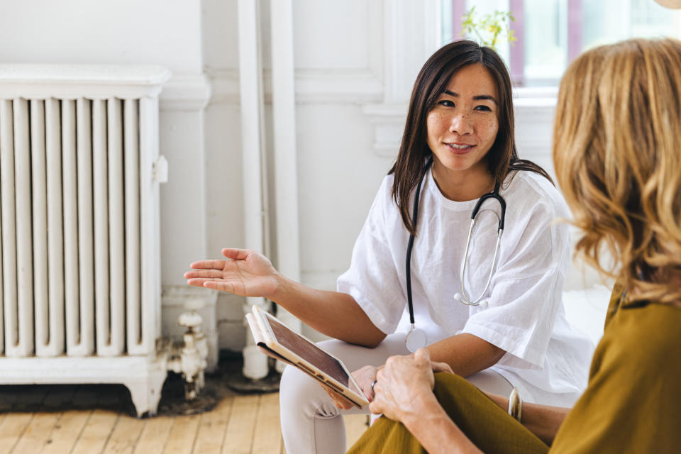 Woman talking to doctor at sexual health clinic