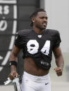 Oakland Raiders' Antonio Brown jogs onto the field before stretching during NFL football practice in Alameda, Calif., Tuesday, Aug. 20, 2019. (AP Photo/Jeff Chiu)