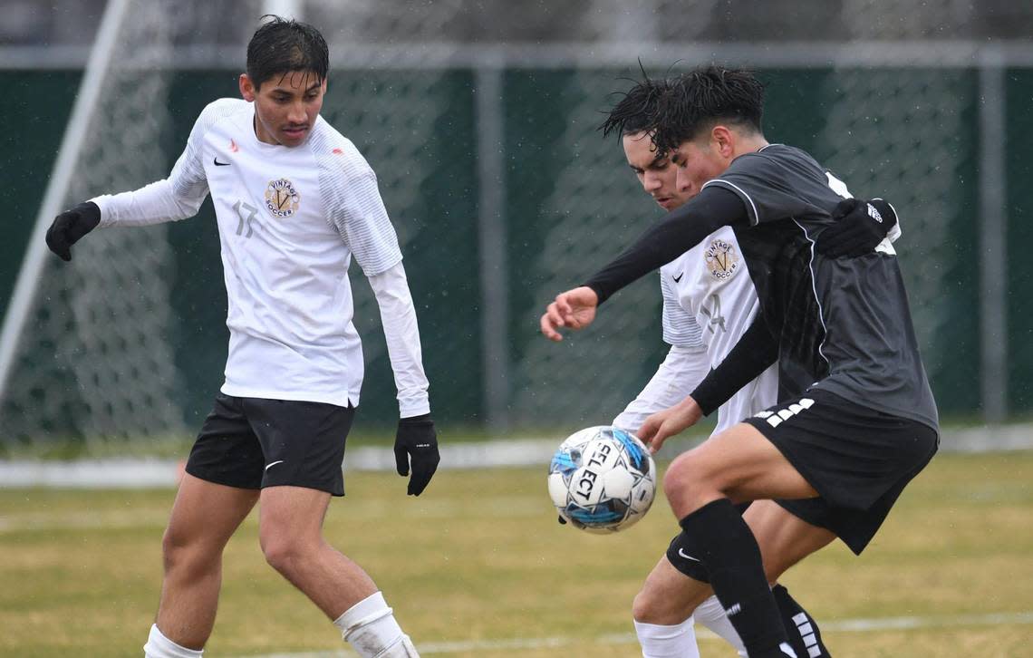 Clovis North’s Bryan Lopez, right, fights for control of the ball with Vintage-Napa’s Noel Lopez, center, with Octavio Castro to the far left, in the CIF Northern California Regional boys playoff game Tuesday, Feb. 2, 2023 in Clovis. Clovis North shutout Vintage-Napa 2-0.
