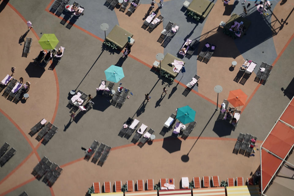 Pool chairs are spread out as a precaution against the coronavirus on the Fourth of July at the Strat hotel-casino Saturday, July 4, 2020, in Las Vegas. (AP Photo/John Locher)