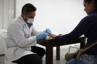 A forensic doctor takes a blood sample from a woman during a day of DNA collection in Sogamoso, Colombia, August 16, 2017. REUTERS/Julia Symmes Cobb