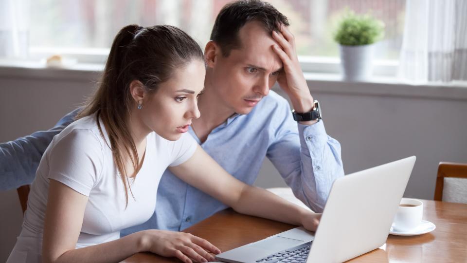 A shocked couple realizing they've been scammed