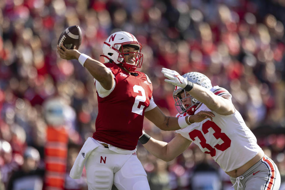 Nebraska quarterback Adrian Martinez (2) passes under pressure from Ohio State's Jack Sawyer (33) during the first half of an NCAA college football game Saturday, Nov. 6, 2021, at Memorial Stadium in Lincoln, Neb. (AP Photo/Rebecca S. Gratz)