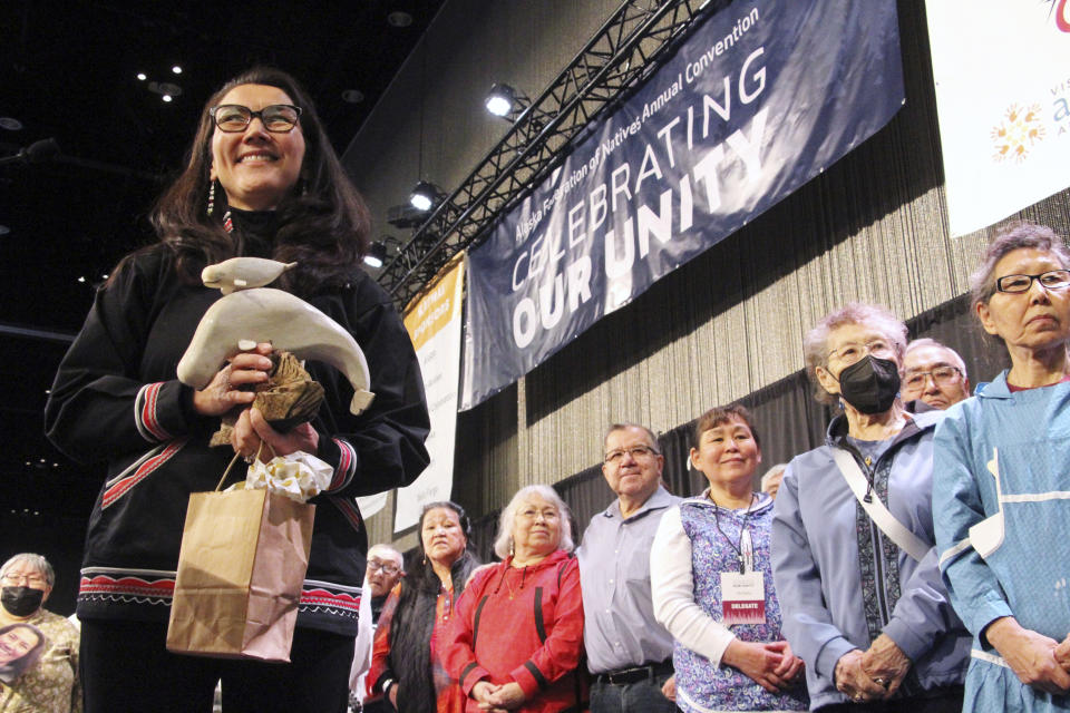 U.S. Rep. Mary Peltola, left, acknowledges audience members singing a song of prayer for her at the Alaska Federation of Natives conference in Anchorage, Alaska, on Thursday, Oct. 20, 2022. Peltola, a Democrat, is the first Alaska Native to be elected to Congress. (AP Photo/Mark Thiessen)
