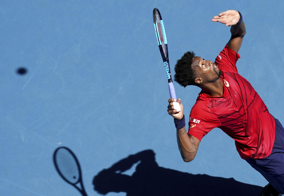 Gael Monfils of France serves to Ernests Gulbis of Latvia during their third round singles match at the Australian Open tennis championship in Melbourne, Australia, Saturday, Jan. 25, 2020. (AP Photo/Lee Jin-man)