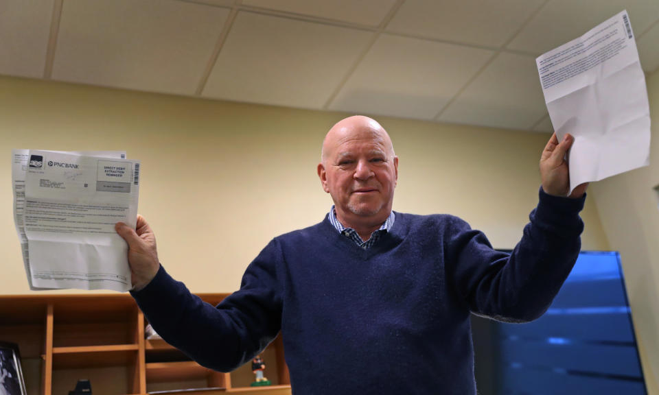 CONCORD, MA - FEBRUARY 27: Arnie Greenfield holds up loan papers in Concord, MA on Feb. 27, 2019. Greenfield is perplexed because the company servicing his son's student loan won't give him credit for paying the loan early on one occasion. Greenfield says he has no complaints about helping his children pay off their college loans. An engineer and high-tech executive, he says hes grateful to be in a position to do so. But he does have a problem with being penalized by a bank for making an early payment. "It was the theater of the absurd, Greenfield said of his dealings with American Education Services, the company that administers the loan for PNC, one of the countrys biggest banks. (Photo by David L. Ryan/The Boston Globe via Getty Images)