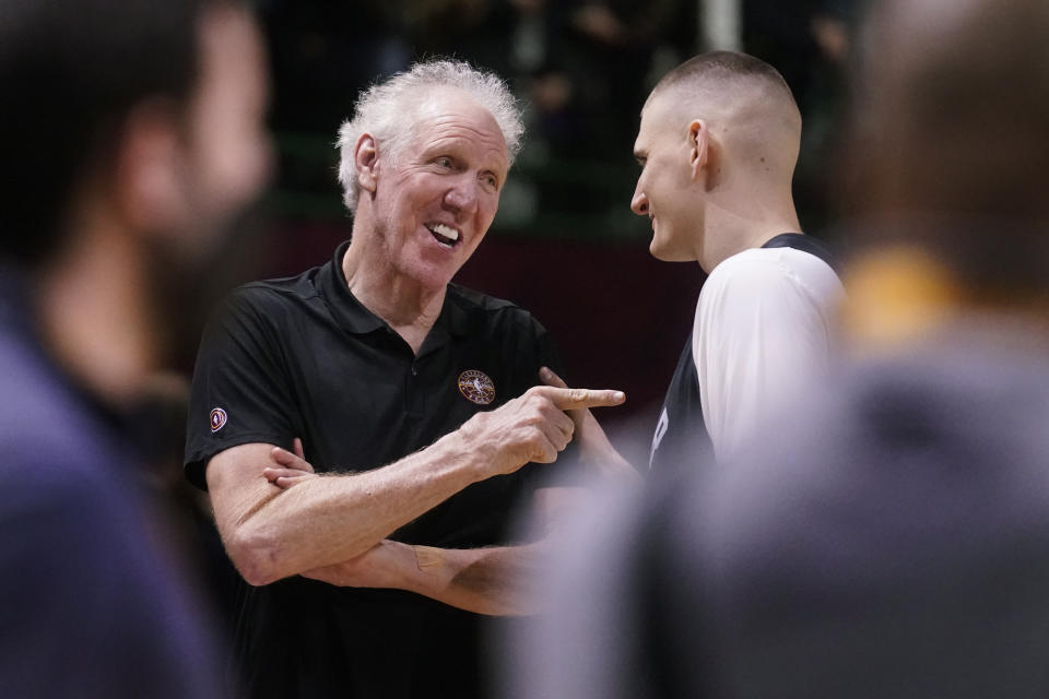 FILE - Basketball Hall of Fame legend Bill Walton, left, jokes with Denver Nuggets center Nikola Jokic during a practice session for the NBA All-Star basketball game in Cleveland, Feb. 19, 2022. Walton, who starred for John Wooden's UCLA Bruins before becoming a Basketball Hall of Famer and one of the biggest stars of basketball broadcasting, died Monday, May 27, 2024, the league announced on behalf of his family. He was 71. (AP Photo/Charles Krupa, File)