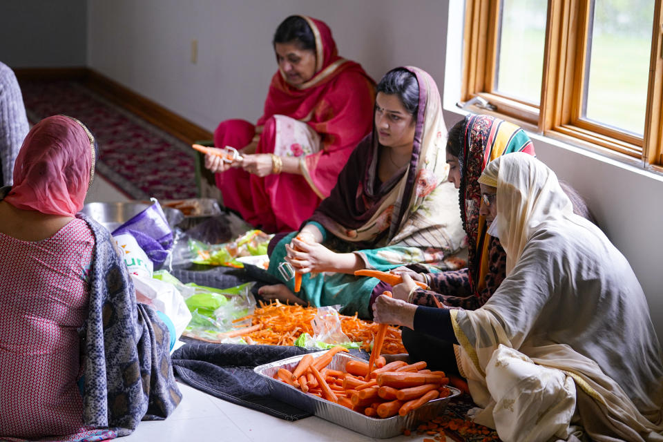 Members of the Sikh Satsang of Indianapolis prepare a communal meal in their Gurdwara building in Indianapolis, Saturday, April 17, 2021 where the Sikh Coalition held a meeting to formulate the groups response to the shooting at a FedEx facility in Indianapolis that claimed the lives of four members of the Sikh community. A gunman killed eight people and wounded several others before taking his own life in a late-night attack at a FedEx facility near the Indianapolis airport. (AP Photo/Michael Conroy)