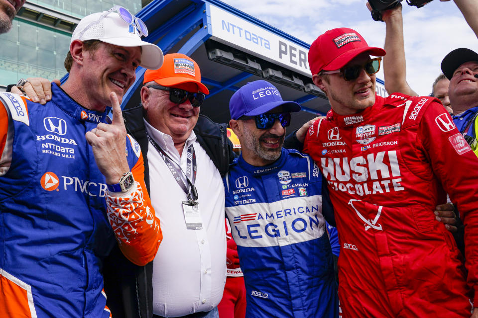 From left to right, Scott Dixon, of New Zealand, celebrates after winning the pole with car owner Chip Ganassi and teammates Tony Kanaan, of Brazil, and Marcus Ericsson, of Sweden, during qualifications for the Indianapolis 500 auto race at Indianapolis Motor Speedway in Indianapolis, Sunday, May 22, 2022. (AP Photo/Michael Conroy)