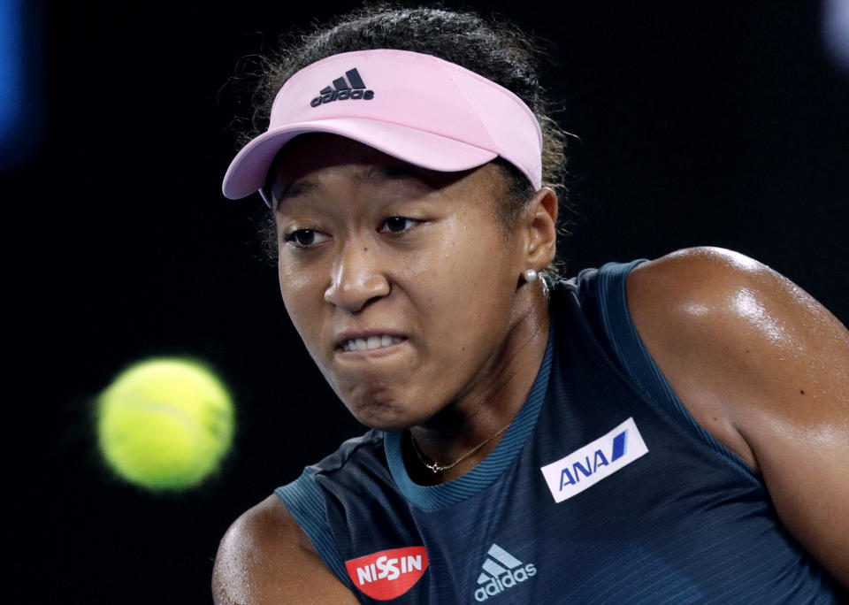 Japan's Naomi Osaka hits a backhand return to Poland's Magda Linette during their first round match at the Australian Open tennis championships in Melbourne, Australia, Tuesday, Jan. 15, 2019. (AP Photo/Kin Cheung)