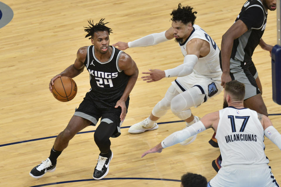 Sacramento Kings guard Buddy Hield (24) handles the ball against Memphis Grizzlies forward Dillon Brooks (24) in the second half of an NBA basketball game Thursday, May 13, 2021, in Memphis, Tenn. (AP Photo/Brandon Dill)