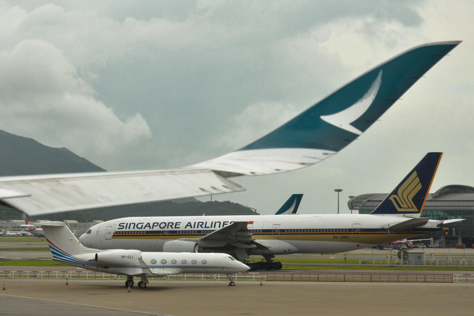 Planes belonging to Singapore Airlines, and the Hong Kong Airline Carrier Cathay Pacific, seen at Hong Kong International Airport in Hong Kong, China.  On Wednesday, July 3, 2019, in Hong Kong, China. (Photo by Artur Widak/NurPhoto via Getty Images)