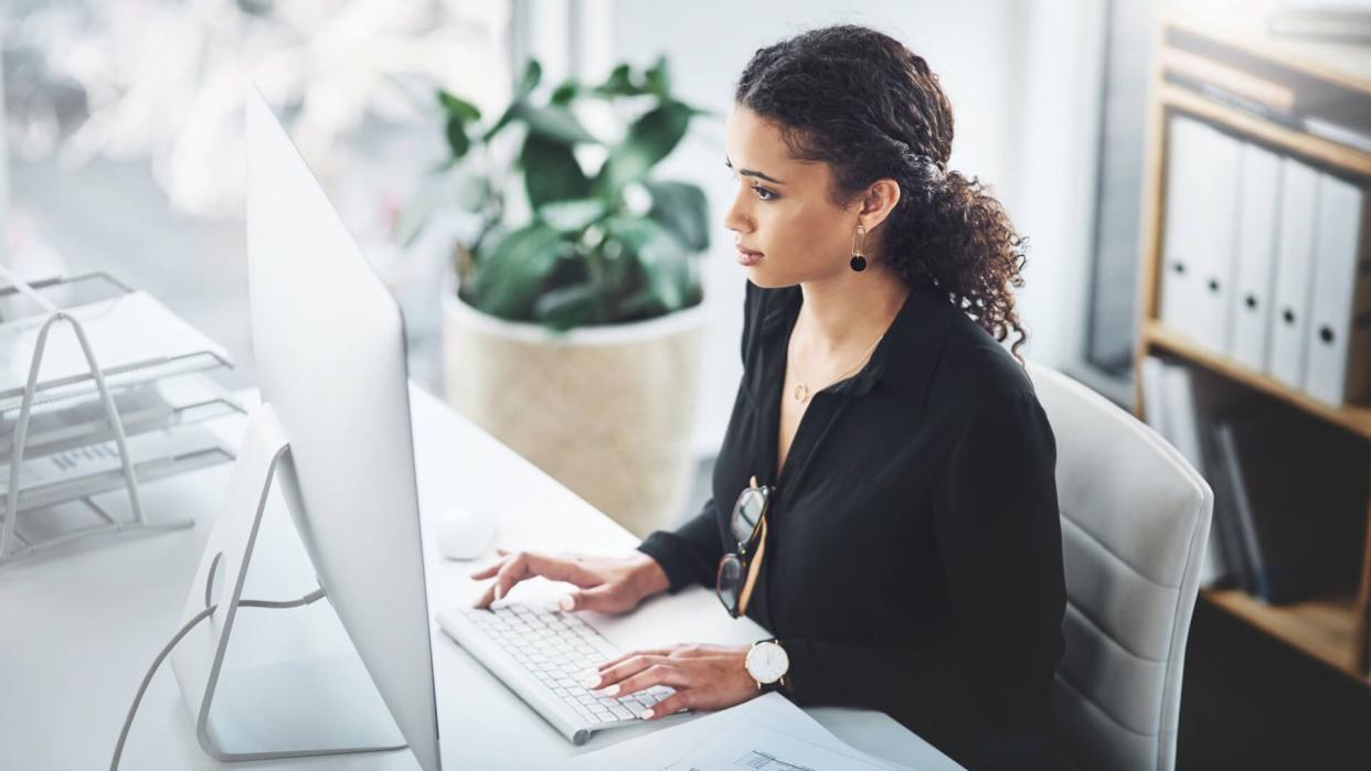 Shot of a young businesswoman working on a computer in an office.