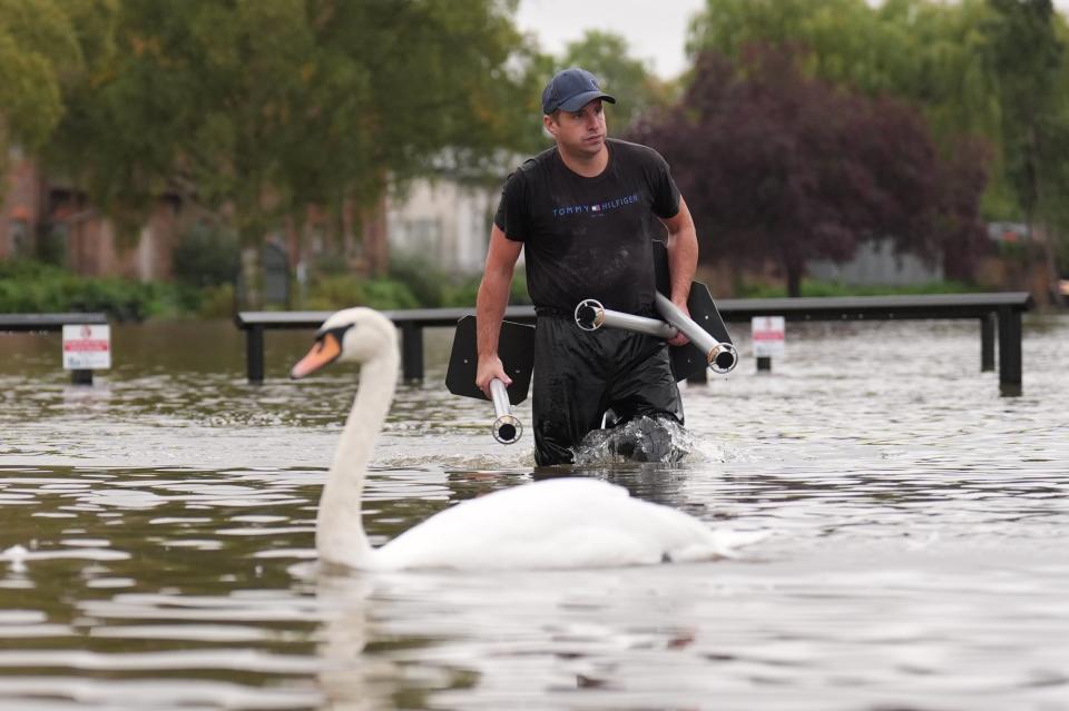 A man wades through flood water in Wellingborough (Joe Giddens/PA Wire)