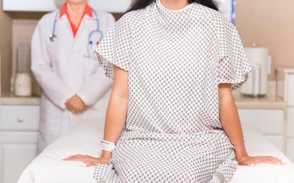 Mid-adult, latin descent woman prepares for her annual breast exam, mammogram from her gynocologist doctor at hospital or clinic. Or woman wearing hospital gown prepares for medical procedure. Senior adult, female doctor. Women's health, issues. Breast cancer awareness - Getty Images Contributor