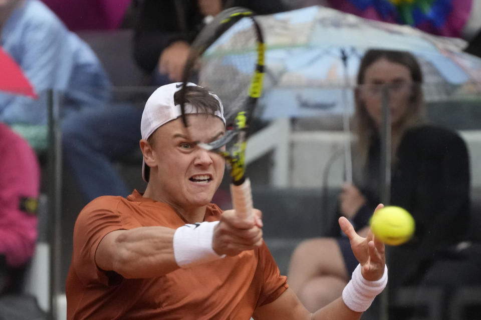 Denmark's Holger Rune returns the ball to Serbia's Novak Djokovic during their quarter final match at the Italian Open tennis tournament, in Rome, Wednesday, May 17, 2023. (AP Photo/Gregorio Borgia)