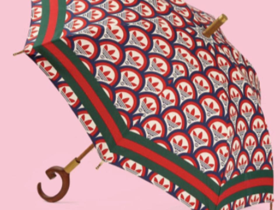 The green and red sun umbrella is a part of a joint Adidas x Gucci collection (Cubist / Twitter)