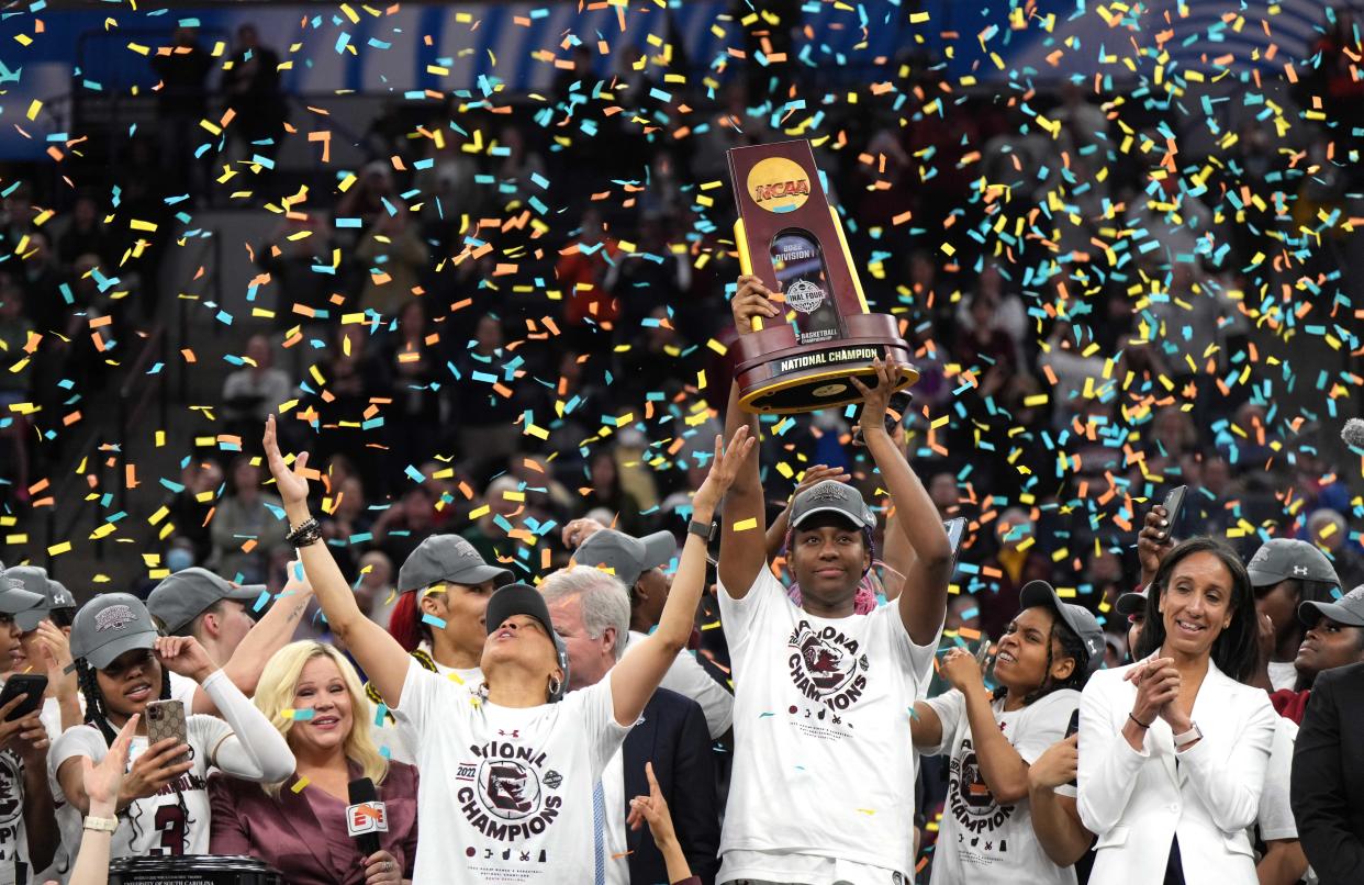 South Carolina head coach Dawn Staley celebrates while forward Aliyah Boston holds up the championship trophy after the Gamecocks' victory over UConn.