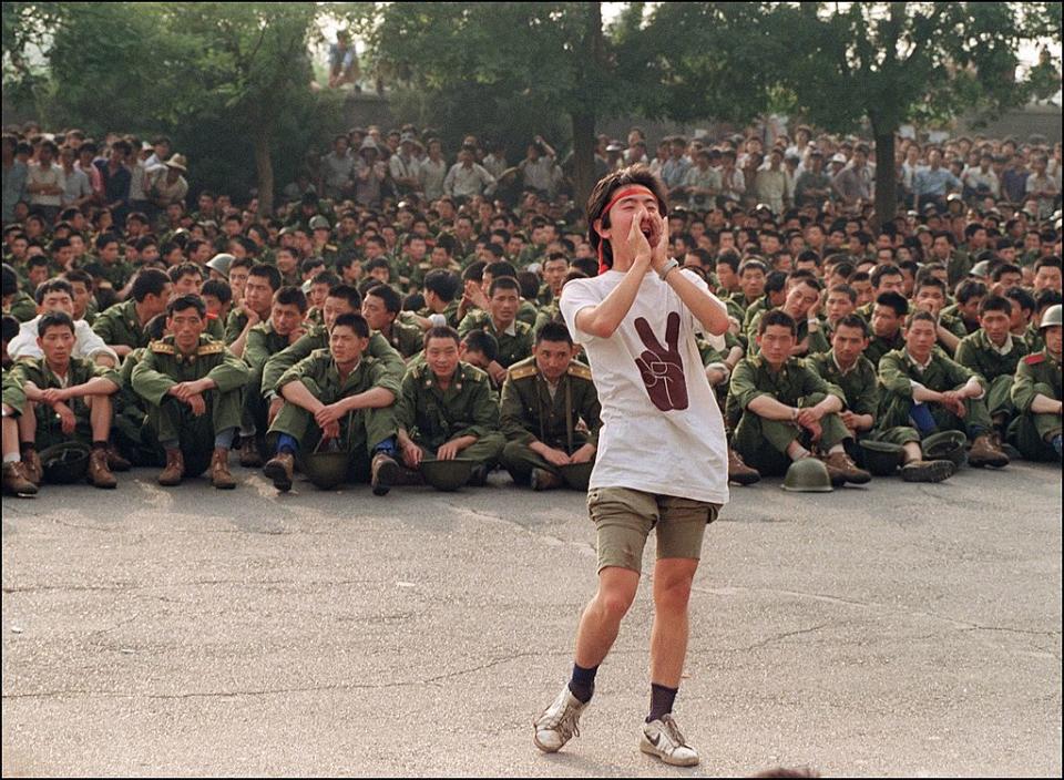 A dissident student asks soldiers to go back home as crowds flooded into the central Beijing June 3, 1989. | Catherine Henriette—AFP/Getty Images