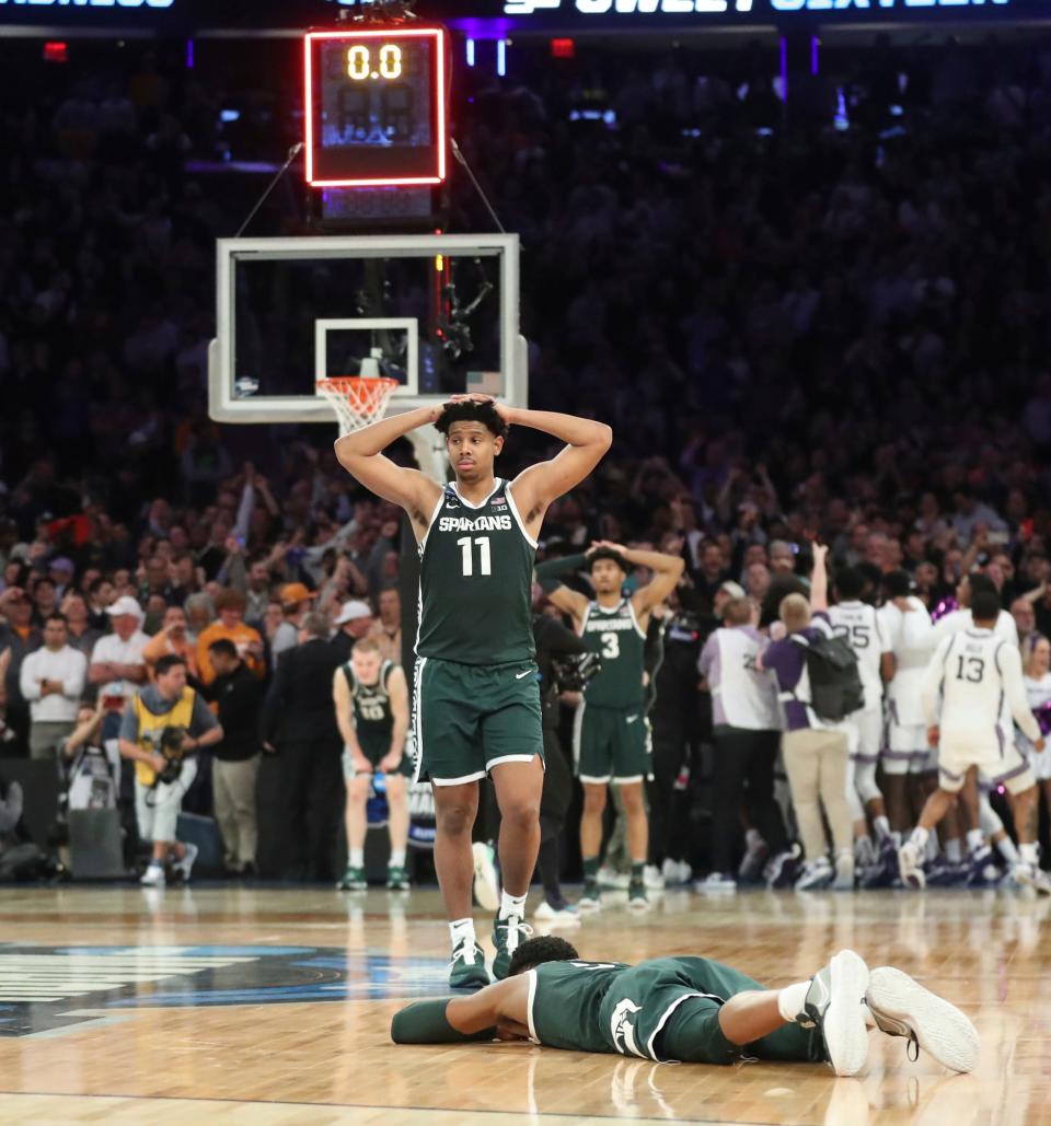 Michigan State guards Tyson Walker, laying on floor, and A.J. Hoggard react after the 98-93 overtime loss to Kansas State in the Sweet 16 on Thursday, March 23, 2023, in New York.