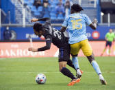 CF Montreal's Mathieu Choiniere (29) collides with Philadelphia Union's Olivier Mbaizo (15) during the first half of an MLS soccer game, Saturday, Oct. 16, 2021, in Montreal. (Graham Hughes/The Canadian Press via AP)