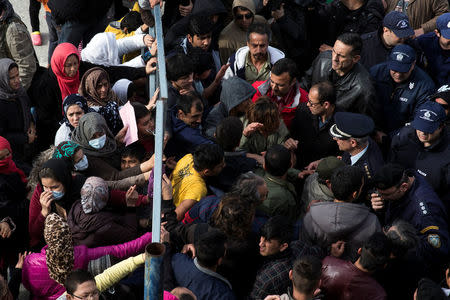 Refugees and migrants, most of them Afghans, block the entrance of the refugee camp at the disused Hellenikon airport as police officers try to disperse them, in Athens, Greece, February 6, 2017. REUTERS/Alkis Konstantinidis