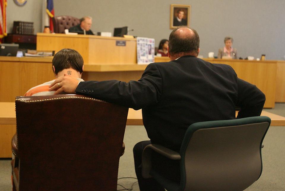 Photo by Larry Kolvoord AMERICAN-STATESMAN....8/1/07....Attorney Jon Evans puts his arm on the shoulder of his client, Justin Crabbe, 19, shortly after Crabbe entered a guilty plea in District Judge Charlie Baird's court Wednesday, August 1, 2007.