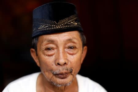 An elderly evacuated man Saifoden Salong poses while stand at his makeshift tent at an evacuation center outside Marawi while government forces still fighting insurgents from the Maute group in Marawi, Philippines June 26, 2017. REUTERS/Jorge Silva