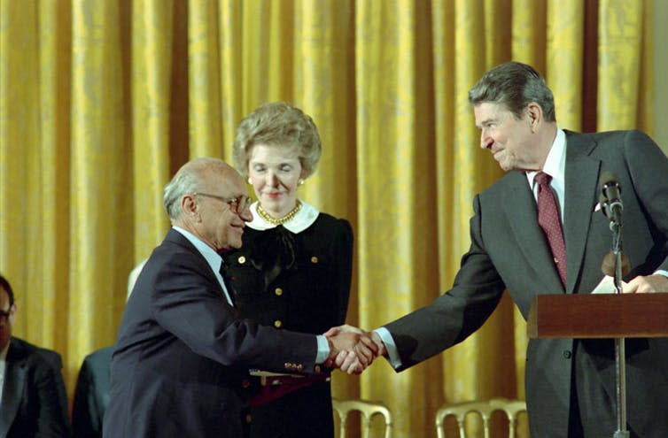 <span class="caption">Ronald Reagan and Milton Friedman said ‘greed is good’.</span> <span class="attribution"><a class="link " href="https://commons.wikimedia.org/wiki/File:Ronald_reagan_congratulating_Milton_Friedman_receiving_the_Presidential_Medal_of_Freedom_C49899-15.jpg" rel="nofollow noopener" target="_blank" data-ylk="slk:Wikimedia;elm:context_link;itc:0;sec:content-canvas">Wikimedia</a></span>