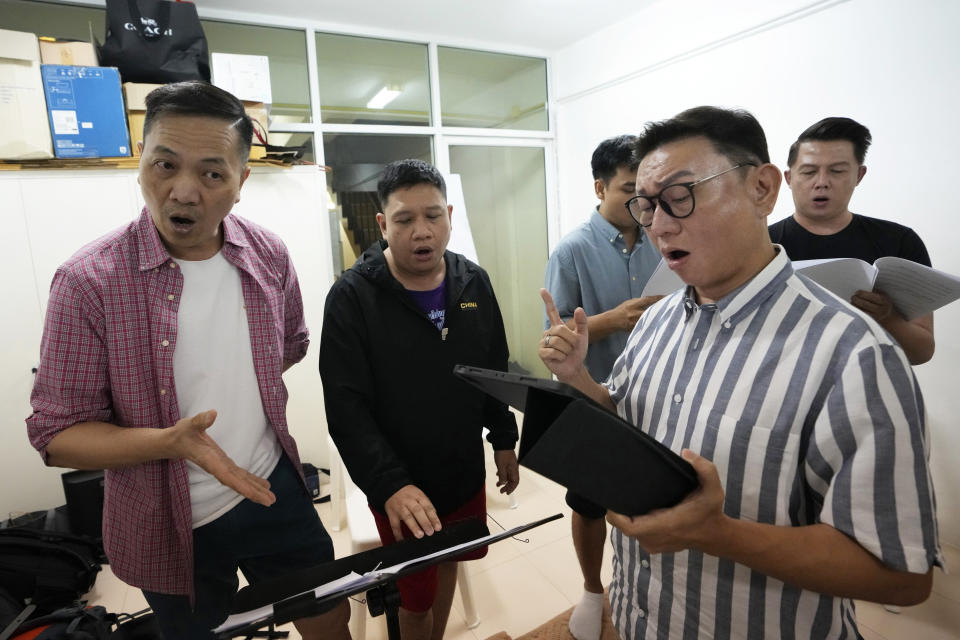 Vocal coach Vuthipand Pongtanalert, front, instructs members of The Bangkok Gay Men's Chorus in a lesson in Bangkok, Thailand, Sunday, Nov. 26, 2023. Thailand's Parliament is set to debate Thursday, Dec. 21, a final cabinet-endorsed draft bill to pass landmark legislation allowing members of the LGBTQ+ community to get married. (AP Photo/Sakchai Lalit)