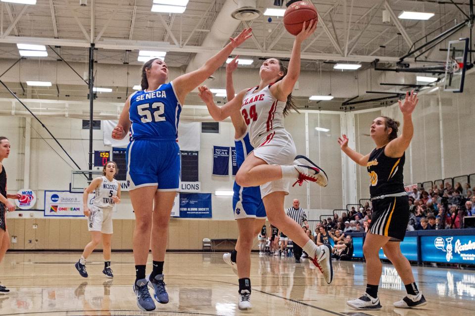  West Girls teamÕs Louisa Opp (24) from General McClane jumps for the shot against East Girls teamÕs Julia Patterson (52) from Seneca, on April 3, 2022, during the Erie County East-West Basketball All-Star Games at Penn State Behrend's Junker Center in Erie. 